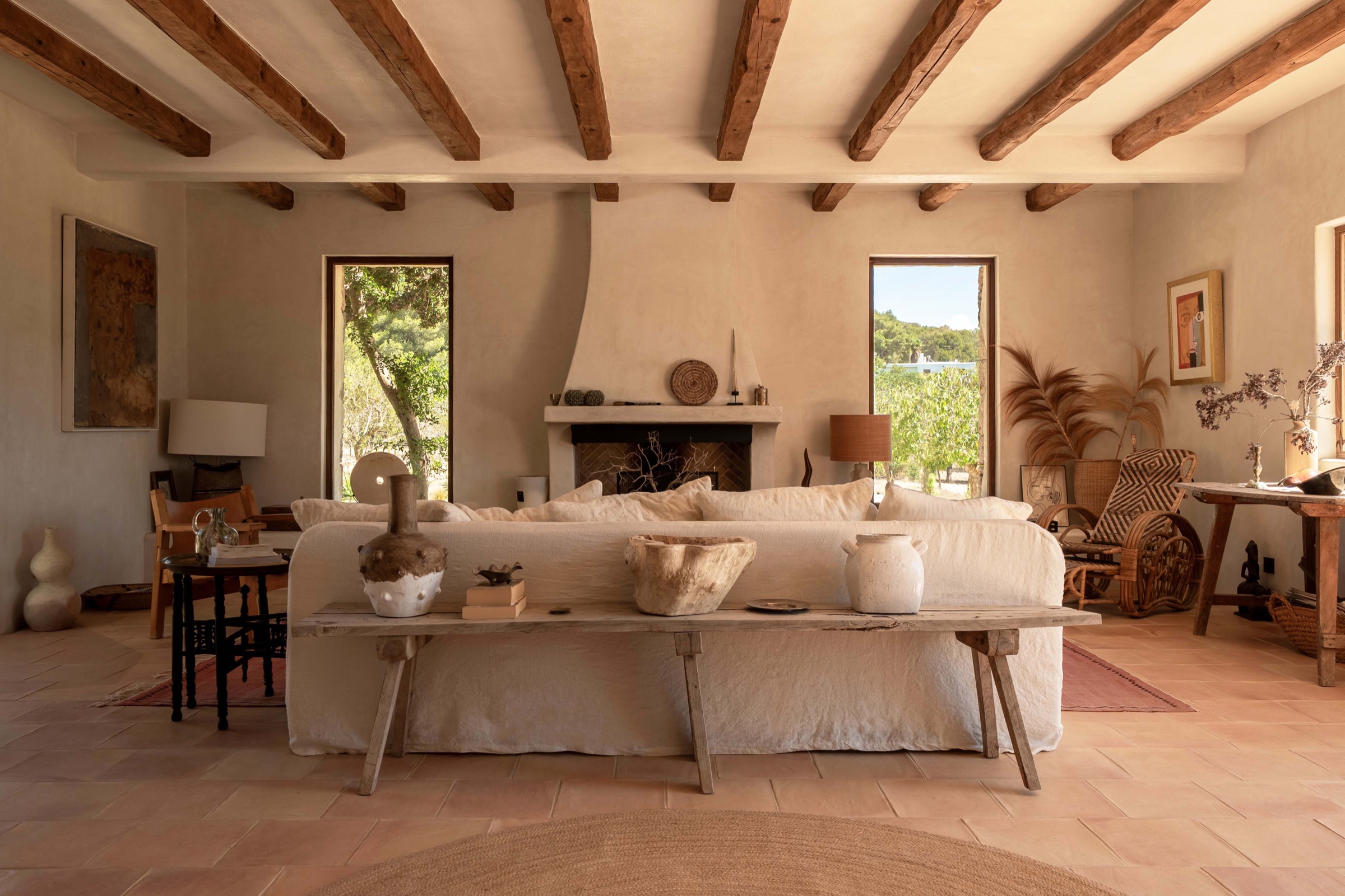 Living room with exposed timber ceiling beams and a stone fireplace